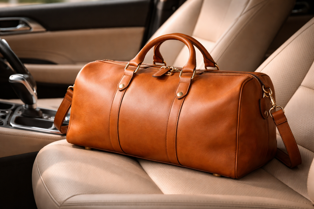 Top grain leather travel duffle bag with a smooth finish and structured design placed on a car seat