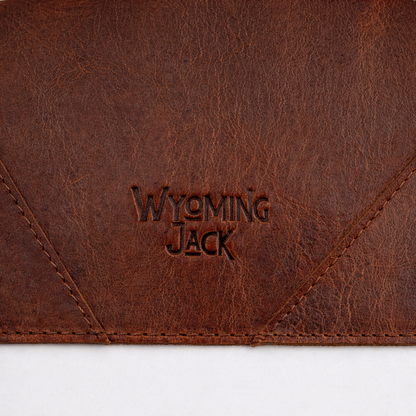 Close-up of Wyoming Jack Cutstone Leather Desk Mat showing smooth leather surface and stitched edges.