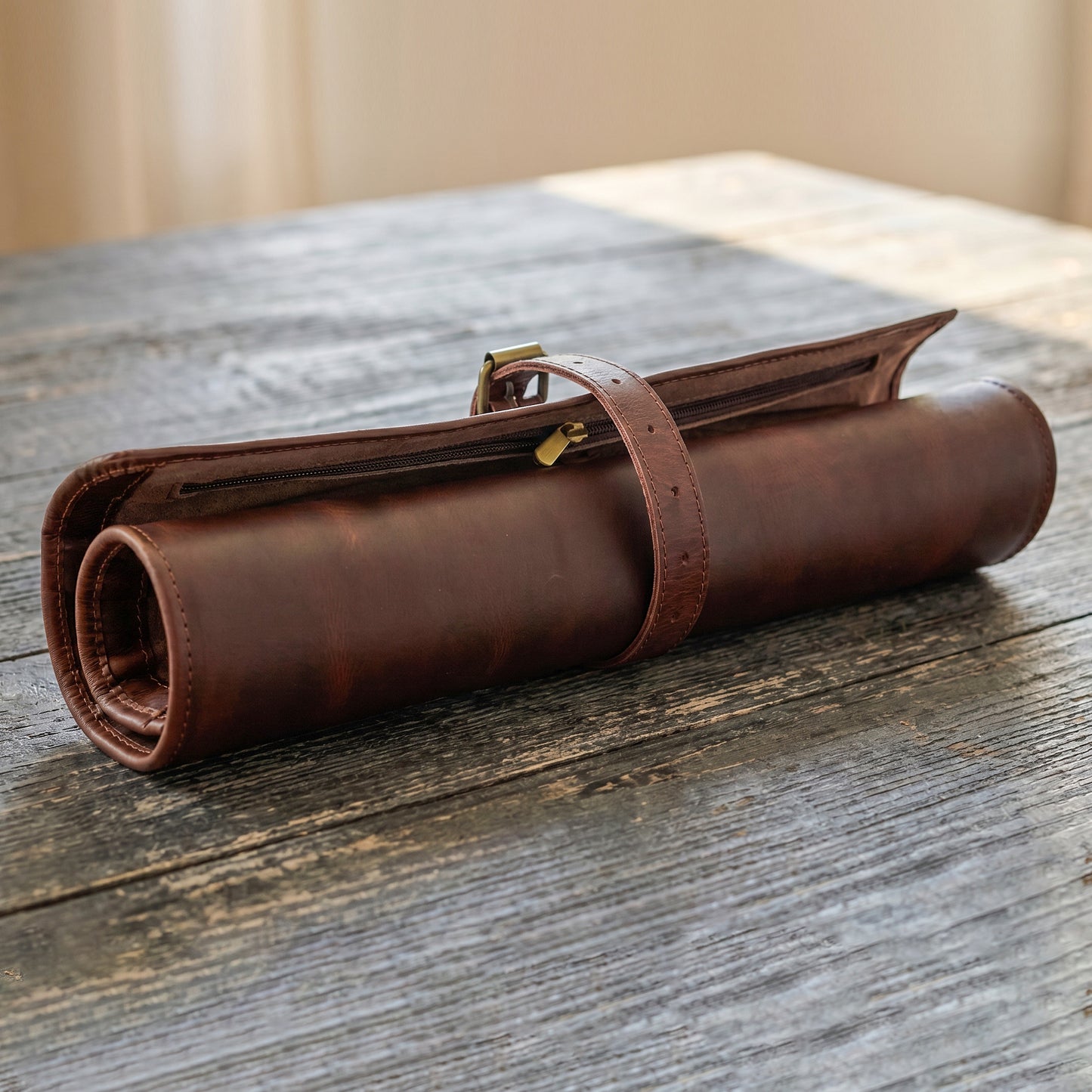 Wyoming Jack CrossCut leather knife roll for chefs with zipper pocket, featuring multiple knife compartments and durable stitching.