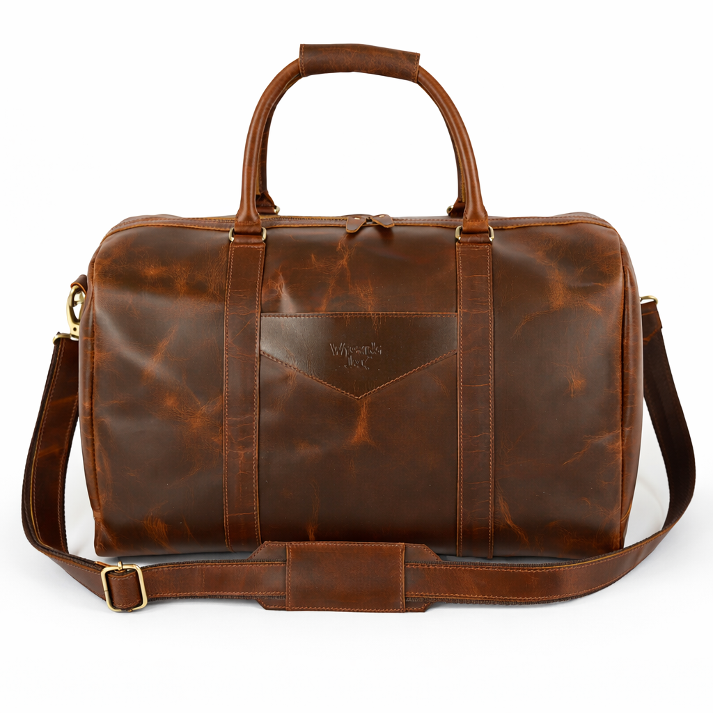 Wyoming Jack Trail Boss leather duffle bag in Brandy color with sturdy handles and spacious main compartment, front view.