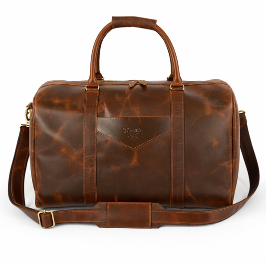 Wyoming Jack Trail Boss leather duffle bag in Brandy color with sturdy handles and spacious main compartment, front view.