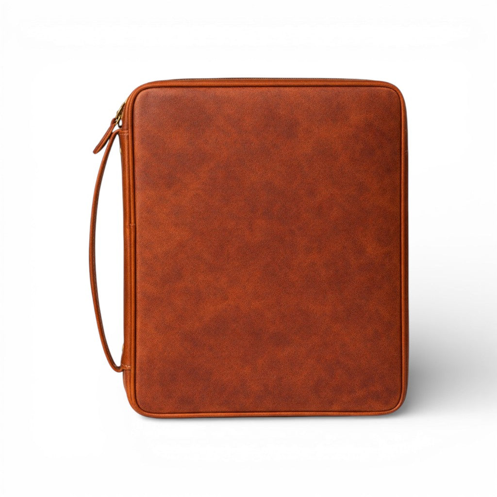 Brown full-grain leather Bible case by Wyoming Jack with zipper closure and organized interior for personal Bible protection.