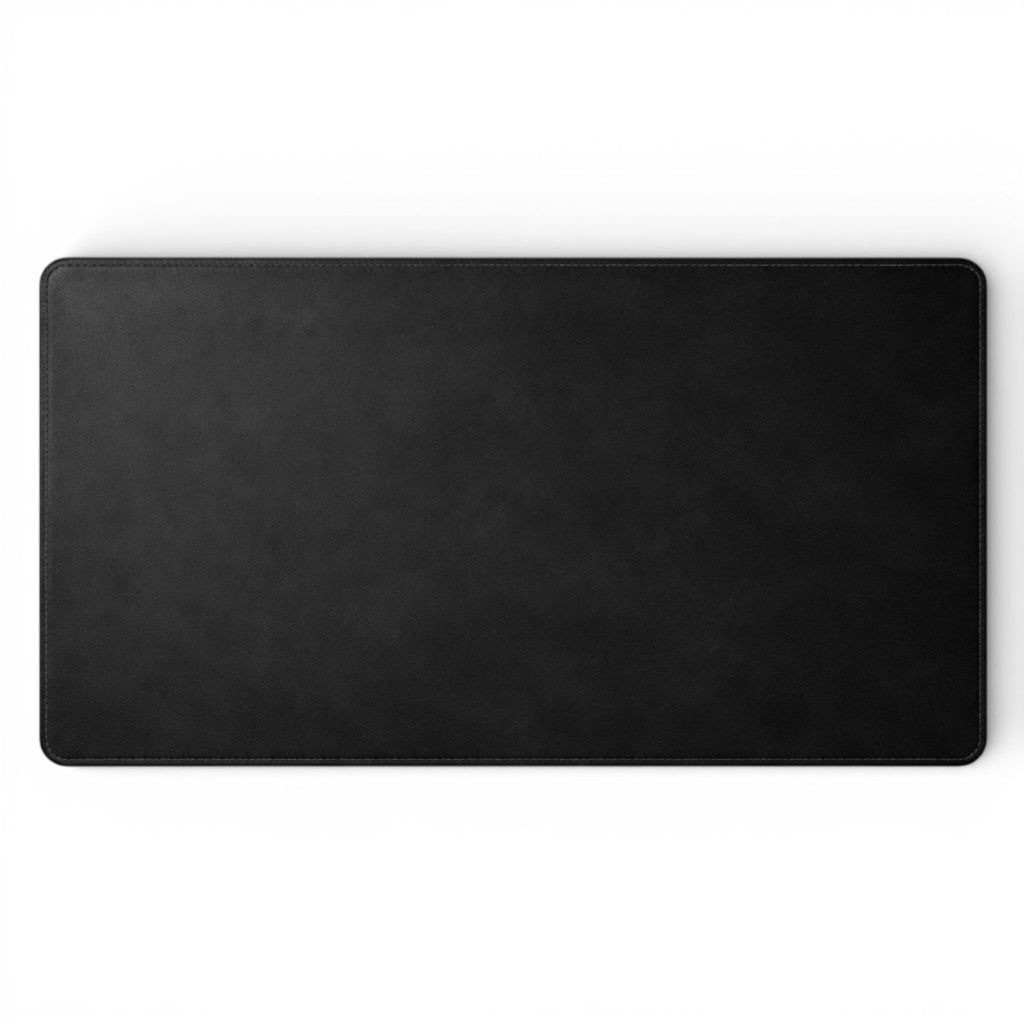 Black full-grain leather desk mat by Wyoming Jack, personalized and custom, shown flat on a workspace.