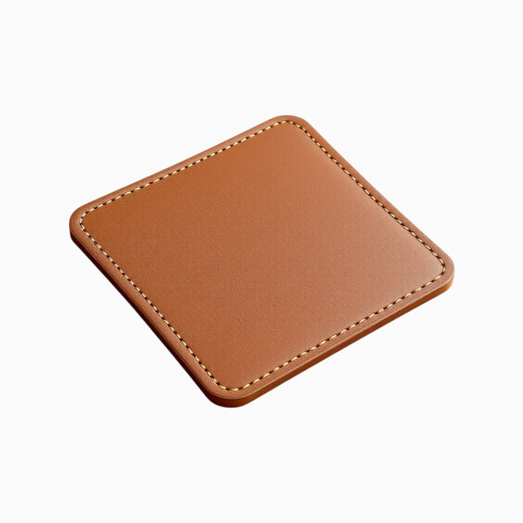 Custom leather coaster by Wyoming Jack with personalized engraving, featuring a smooth brown leather surface and detailed stitching.